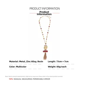 Detailed view of bohemian tassel necklace with zinc alloy charms and resin beads