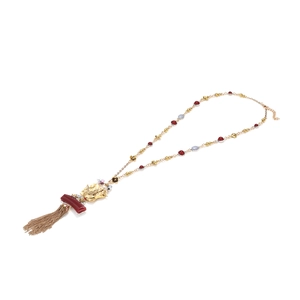 Vintage long tassel necklace featuring a golden beast pendant and red bead accents