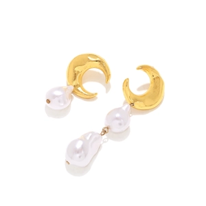 Asymmetric gold crescent moon and baroque pearl drop earrings on white background