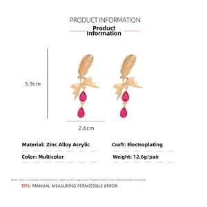 Detailed size and material specs for layered feather and bow earrings with red teardrops