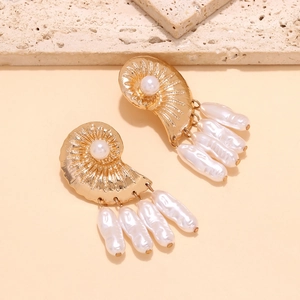Golden shell earrings with baroque pearls in a Mediterranean vacation style set on stone