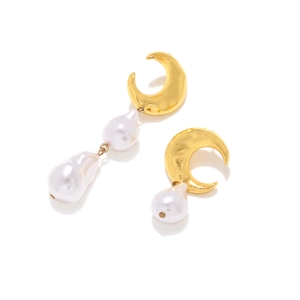 Detail of asymmetric gold moon earrings with baroque pearl drop in minimalist style