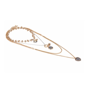 Multilayered gold and silver necklace with heart pendant and coin charms on white background
