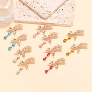 Detail of multi-layered feather bow earrings with colorful teardrop crystal pendants