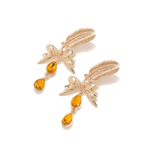 Detail of gold ribbon earrings featuring delicate feathers and amber teardrop stones