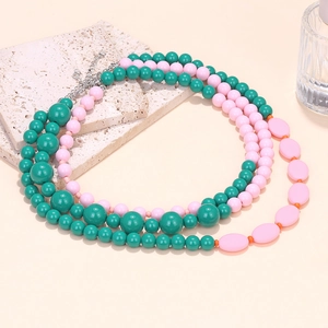 Multi-layer pastel macaron beaded necklace with colorful resin stones on a stone base