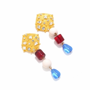 Detail of luxury resin earrings with gold relief, crystals and colorful dangling beads