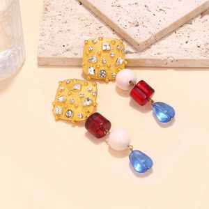 Detailed close-up of luxury resin drop earrings with gold square base and colorful beads