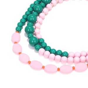 Multilayer beaded necklace with green and pink macaron beads in a bohemian layered style