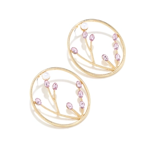 Detailed shot of vintage gold flower earrings with pink crystals and pearls on white