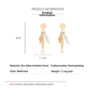 Detailed view of long baroque pearl earrings with golden fish pendants and dimensions
