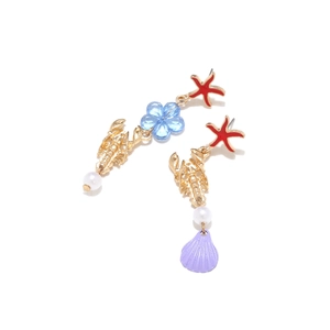 Detailed close-up of asymmetric ocean earrings with starfish, lobster and pearl charms