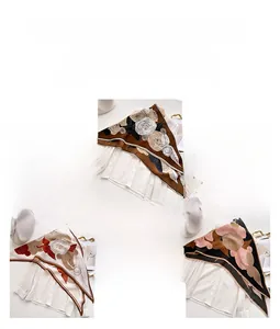 Detailed view of three elegant camellia floral scarves in silk-like satin fabric