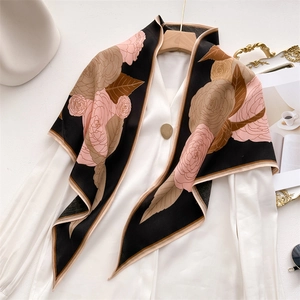 Elegant herringbone velvet shawl with camellia print, styled over a white blouse