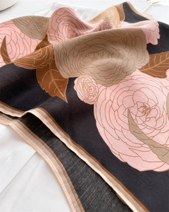 Detailed view of camellia floral print on herringbone velvet shawl with soft texture