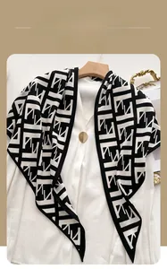 Detail of winter knit scarf featuring black and white herringbone and geometric patterns
