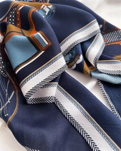 Detail of luxury silk scarf showing twill texture and geometric navy pattern
