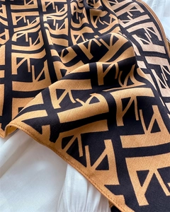 Detail of herringbone velvet triangle scarf with monogram print and soft texture
