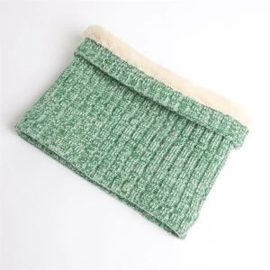 Detail of green ribbed knit scarf with warm white fleece lining for winter neck protection