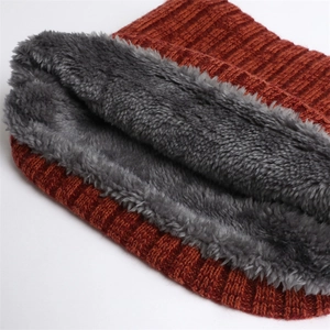 Close-up of rust red ribbed knit with thick grey plush lining for winter warmth