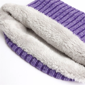 Close-up of purple ribbed knit neck warmer with thick white faux lamb wool lining detail