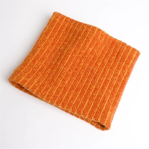 Detailed macro view of orange and yellow ribbed knit texture on a warm winter neck warmer