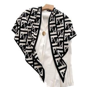 Herringbone velvet triangle scarf with black and white geometric pattern and modern design