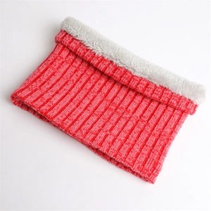 Detail of red ribbed knit winter neck warmer with thick faux fur lining for warmth