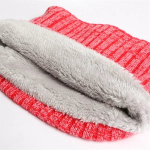 Close-up of red ribbed knit texture and soft grey faux fleece lining for warmth