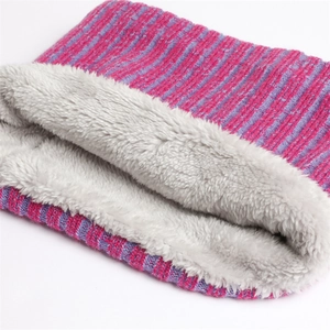 Detailed view of magenta rib-knit scarf with thick grey faux fur lining for winter warmth