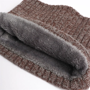 Detail of chunky rib knit scarf with warm grey fleece lining and tan cable texture