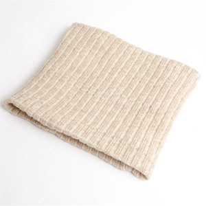 Close-up of beige rib-knit winter neck warmer showing thick elastic texture and soft yarn