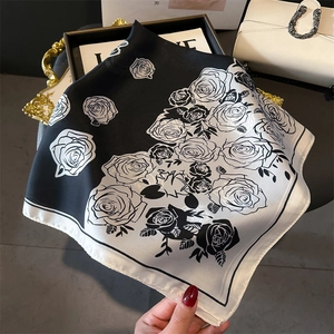 Close-up of black and white rose floral print on satin silk square scarf with fine edges