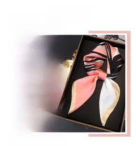 Close-up of elegant silk scarves displayed in a premium gift box with diverse patterns