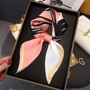 Elegant geometric print silk scarf with pink and black blocks in a premium gift box