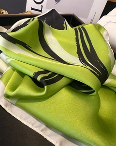 Detail of silk-like satin scarf featuring abstract brush strokes and bright green texture