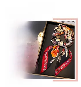 Detail of floral printed satin square scarf with elegant botanical patterns and silky texture