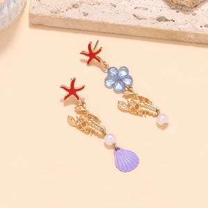 Vintage ocean-themed asymmetric earrings featuring red starfish and golden lobster charms