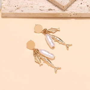 Baroque pearl drop earrings with gold ocean fish pendants in a layered bohemian style