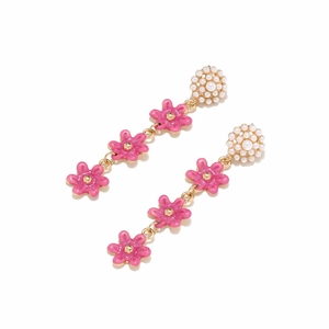 Detail of pink enamel flower earrings with white pearls and gold plated alloy hooks