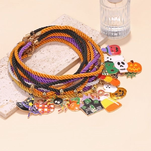 Detailed view of Halloween charm bracelets with ghost, pumpkin, and witch hat pendants