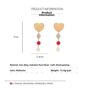 Detail view of heart-shaped baroque pearl drop earrings with dimensions 7cm by 2.4cm