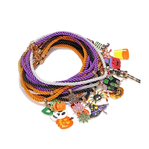 Detailed set of colorful Halloween braided bracelets with enamel charms on white background