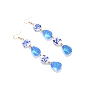 Irregular geometric ceramic drop earrings with blue resin beads and floral pattern