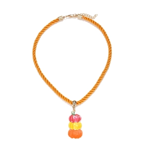 Close-up of three-tier stacked pumpkin pendant on orange rope for Halloween jewelry