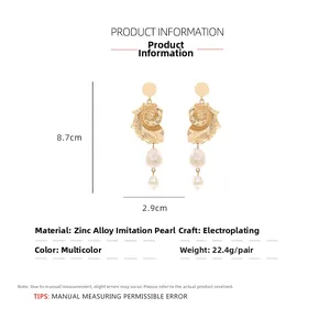 Detailed view of conch shell earrings with baroque pearls and gold plating size specs