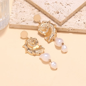 Elegant gold shell earrings with long Baroque pearl tassels in a maritime holiday style