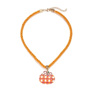Detail of orange checkered pumpkin pendant with pink bow on braided cord necklace