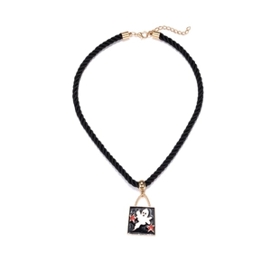Detail of square black enamel ghost pendant with red stars on a twisted rope necklace