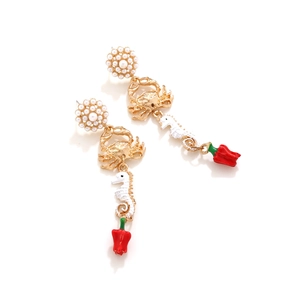 Retro golden crab and seahorse earrings with red chili pendants on white background